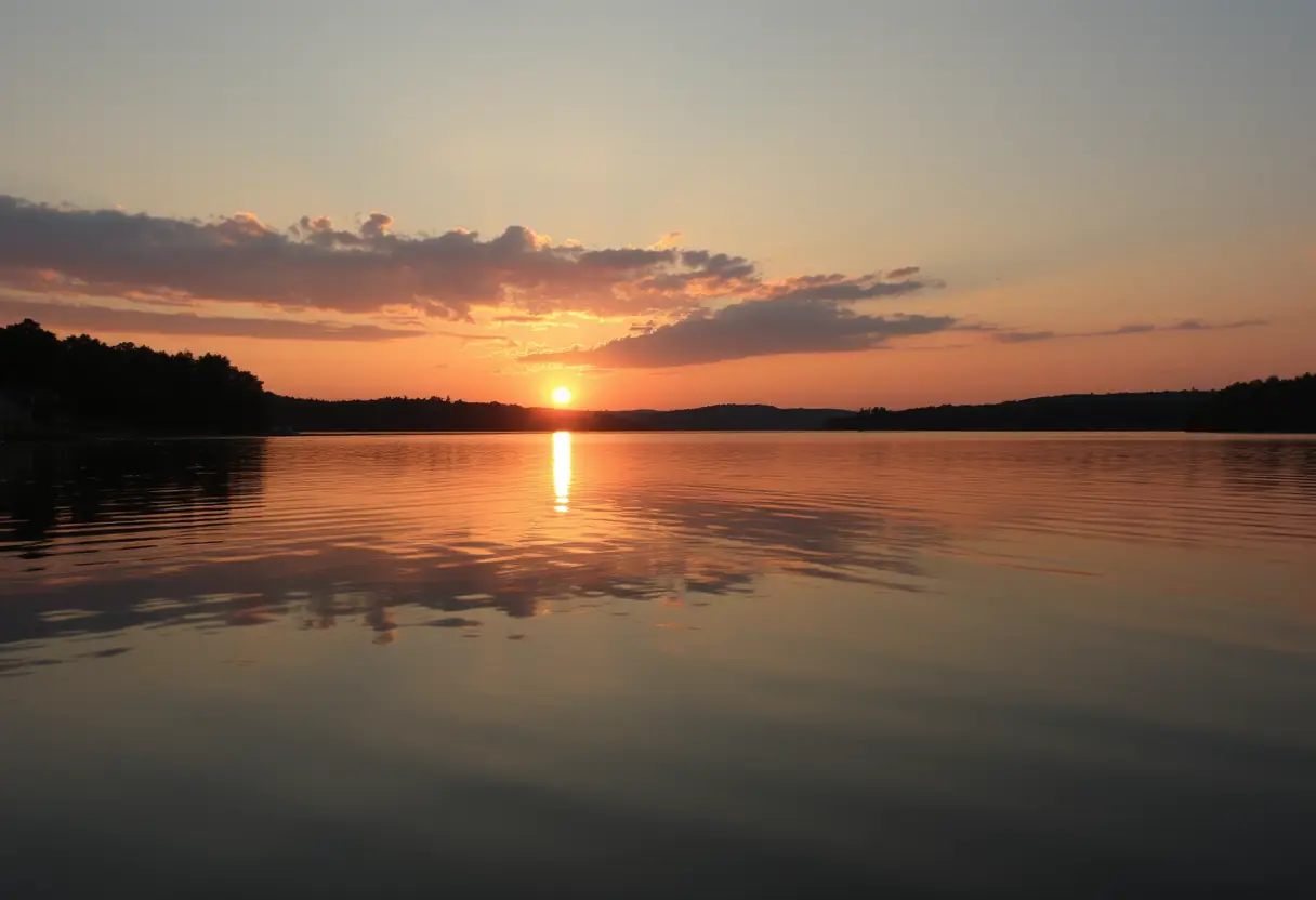 Vue d'un lac calme au coucher du soleil, apaisant les âmes en transition